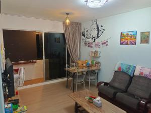 a living room with a couch and a table at Kluang Countryside Scenery NO LIFT SECOND FLOOR#NETFLIX#RETRO GAME in Kluang