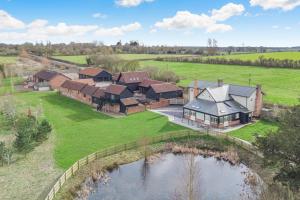 an aerial view of a house with a pond at 2 Bed in Heveningham oc-w29034 in Heveningham