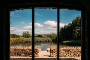 a view of a river from a glass window at Laythams Holiday Lets Retreat in Slaidburn