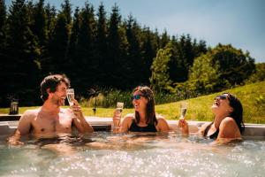 a group of people drinking wine in a hot tub at Laythams Holiday Lets Retreat in Slaidburn