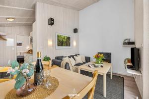 a living room with a couch and a table in a room at Ferienhaus Brocken - Sankt Andreasberg im Harz in Sankt Andreasberg