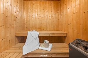 a wooden sauna with a towel on a table at Ferienhaus Brocken - Sankt Andreasberg im Harz in Sankt Andreasberg +25 photos