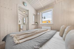 a large bed in a room with a window at Ferienhaus Brocken - Sankt Andreasberg im Harz in Sankt Andreasberg