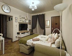 a bedroom with a bed and a clock on the wall at Dimoramica LTB in Foligno