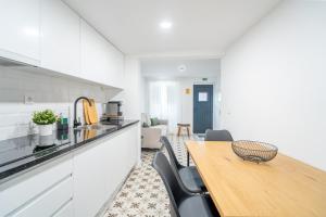 a kitchen and dining room with a wooden table at Casa dos Bonecos in Estremoz +19 photos