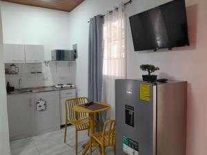a kitchen with a refrigerator and a table with chairs at EL sunzal Bliss #8 in El Sunzal