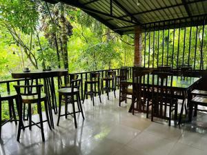 a group of tables and chairs on a patio at Niwana Resort in Ratnapura
