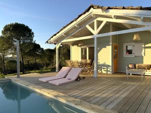 a house with a deck and a swimming pool at Cabana in Sesimbra