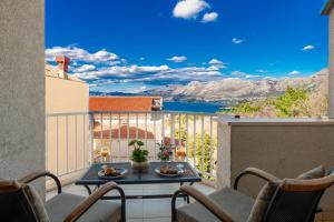 a balcony with a table and chairs and a view at Villa Nick in Cavtat