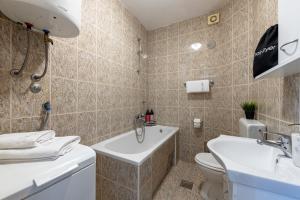 a bathroom with a toilet and a sink at Villa Nick in Cavtat +50 photos