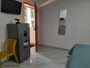 a living room with a refrigerator and a chair at EL sunzal Bliss #8 in El Sunzal