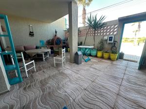 a living room with a couch and a table and chairs at Villa L'initiale in Oualidia