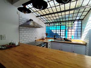a kitchen with a wooden counter top in front of a window at Cocina Bajo las Estrellas in Martínez