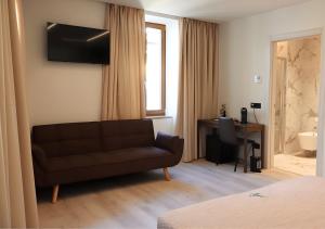 a living room with a couch and a desk at Tower Suite Trento in Trento