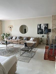 a living room with a couch and a table at Casa Della Baia With a beautiful view in Varazze