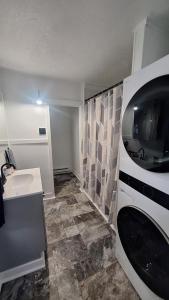 a bathroom with a sink and a microwave at Oswego 2BR Ground-Floor Apt Near SUNY, Walk to Downtown & Lake Ontario in Oswego