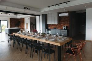 a long wooden table and chairs in a room at VILLA nad JEZIOREM in Mucharz