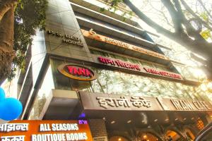 a tall building with signs on the side of it at All seasons boutique rooms in Pune