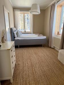 a bedroom with a bed and a window at Snöbergets Arctic Cabin in Luleå