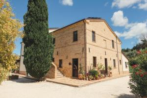 an old building with a tree in front of it at Agriturismo Scala - Eco Boutique B&B in Le Marche in Potenza Picena