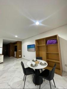 a dining room with a white table and chairs at Central Sweet Stay in Tangier