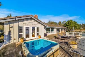 a house with a swimming pool on a deck at Shaws Cove Beachouse in Gig Harbor
