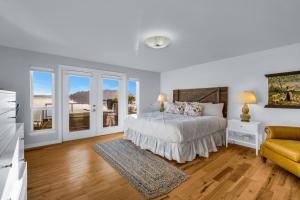 a white bedroom with a bed and a couch at Shaws Cove Beachouse in Gig Harbor +44 photos