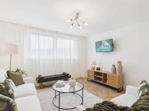 a living room with a couch and a table at The Bridge View Apartment in Hawick