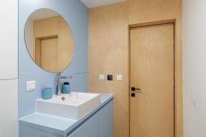 a bathroom with a white sink and a mirror at Super apartmán - self check in, free private parking, balcony in Banská Bystrica +13 photos