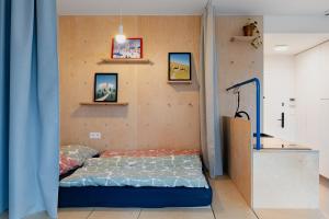 a bed in a room with a blue curtain at Super apartmán - self check in, free private parking, balcony in Banská Bystrica