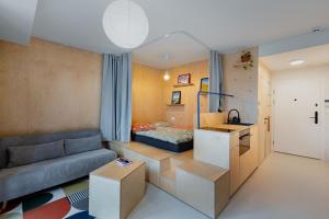 a small living room with a couch and a bed at Super apartmán - self check in, free private parking, balcony in Banská Bystrica