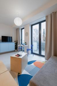 a room with a bed and a living room with a table at Super apartmán - self check in, free private parking, balcony in Banská Bystrica