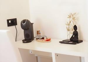 a desk with a computer and a speaker on it at Tower Suite Trento in Trento +15 photos