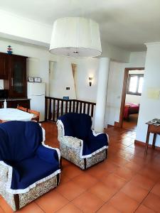 a living room with two chairs and a table at Casa da Avó Maria in Podence