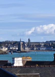 a large body of water with a city in the background at Ker Marlyne - Proche du Port in Dinard