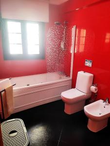 a bathroom with a tub and a toilet and a sink at Casa da Avó Maria in Podence