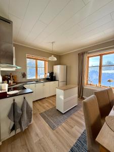 a kitchen with white cabinets and a counter top at Snöbergets Arctic Cabin in Luleå