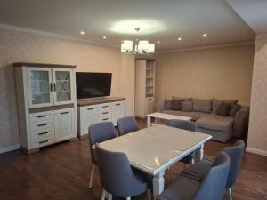 a living room with a couch and a table and chairs at Апартаменти Вілла Гор in Bukovel