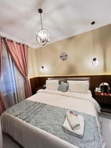 a bedroom with a large bed with towels on it at Hotel de l'Air in Douala +28 photos