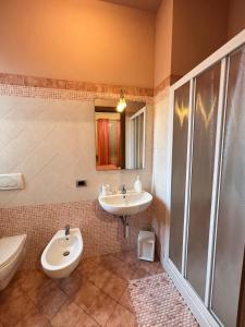 a bathroom with a sink and a toilet and a shower at Locanda Fuoriporta in Cantagrillo