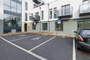 a parking lot with a car parked in front of a building at Super apartmán - self check in, free private parking, balcony in Banská Bystrica