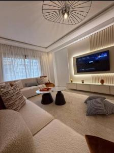 a living room with a couch and a tv at Central Sweet Stay in Tangier
