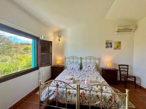 a bedroom with a bed and a large window at Country Guest House in Cardedu +30 photos