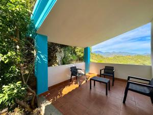a room with a balcony with chairs and a view at Country Guest House in Cardedu