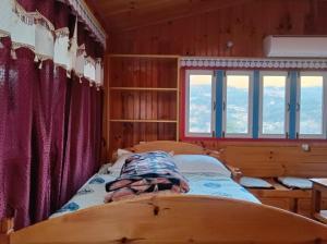 a bed in a room with red curtains at Sagun's Place in Phāphlu