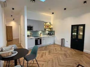 a kitchen with a table and chairs in a room at Old Library Apartments - 8a in Orkney
