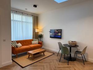 a living room with a couch and a table at Old Library Apartments - 8a in Orkney