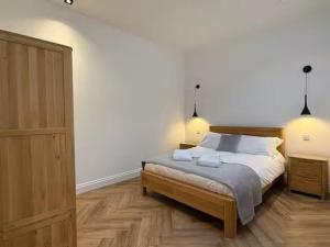 a bedroom with a bed and a dresser at Old Library Apartments - 8a in Orkney
