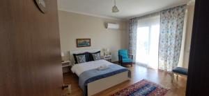 a bedroom with a bed and a large window at Ephesus Suites in Selçuk +53 photos