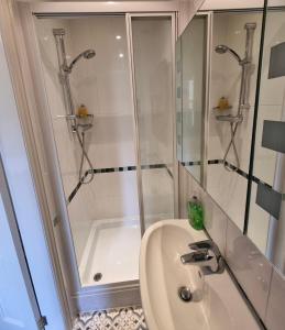 a white bathroom with a shower and a sink at Bod Gwynedd Bed and Breakfast in Betws-y-coed +45 photos